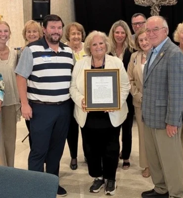 Terri Nichols and co-workers celebrate H of R award.